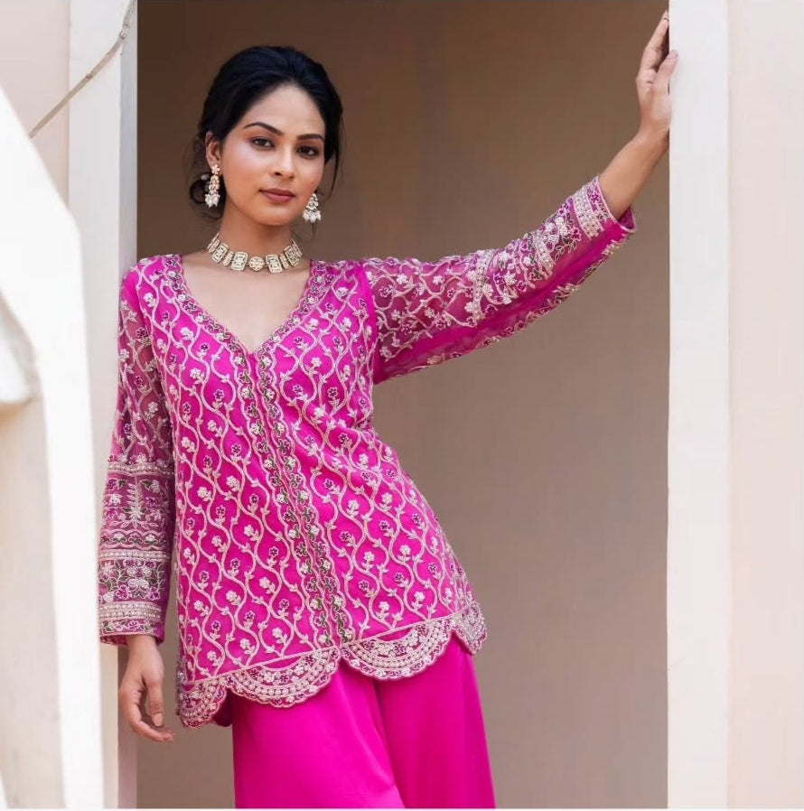 Pink swiss net peplum top with heavy satin lehenga pallazo