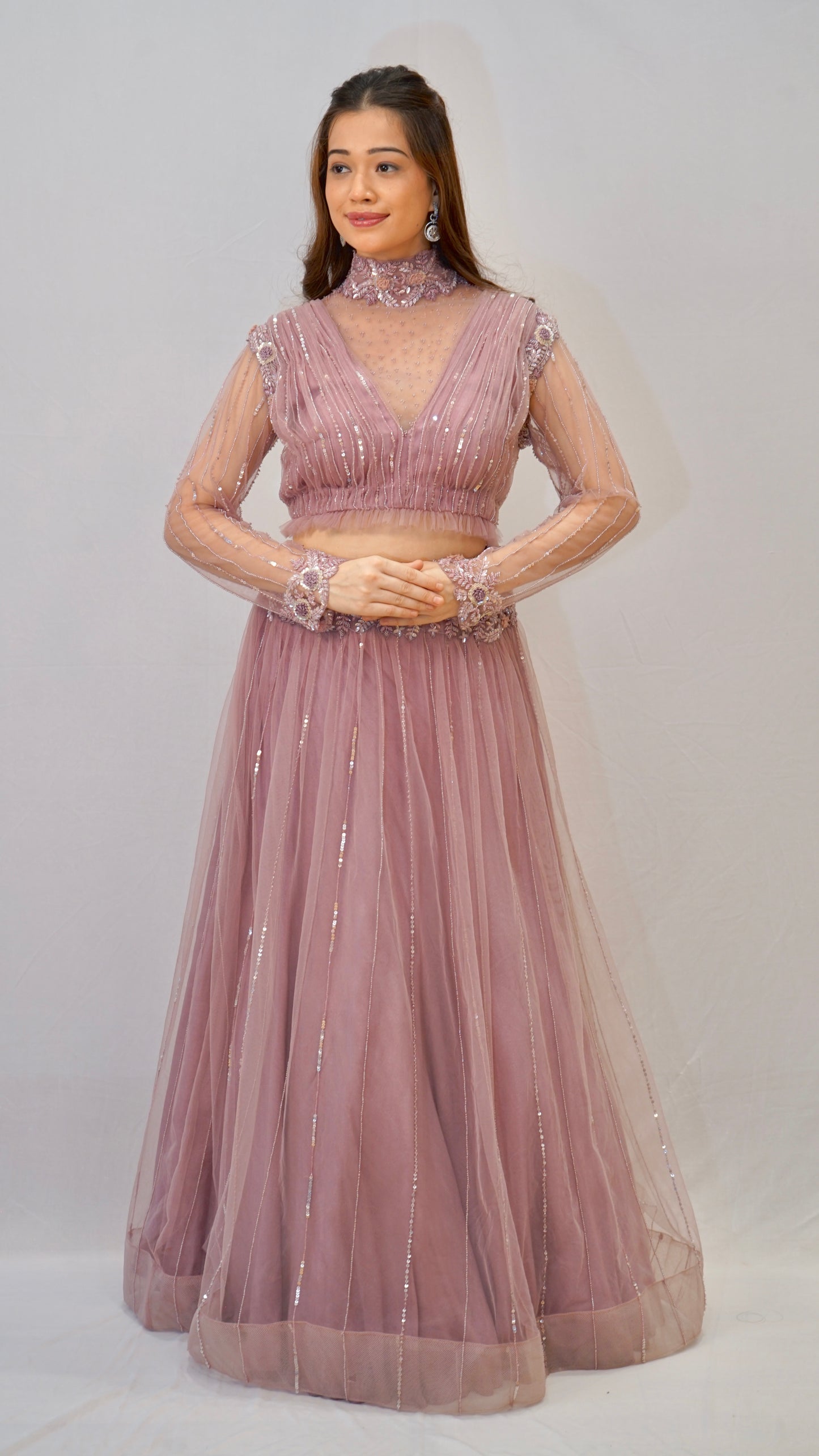 Purple turtle neck blouse with heavy net lehenga