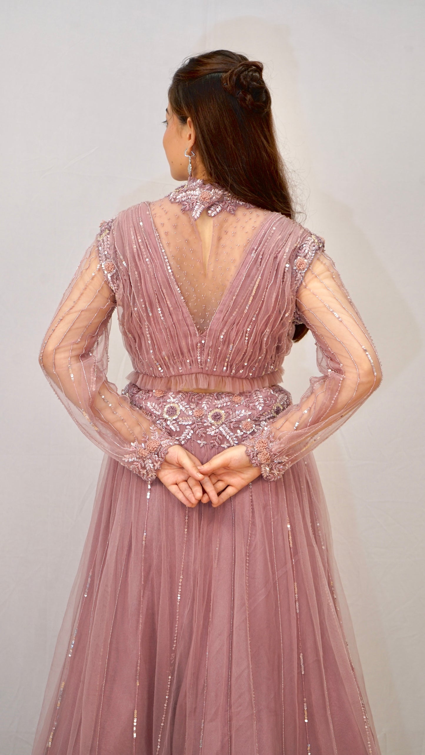 Purple turtle neck blouse with heavy net lehenga